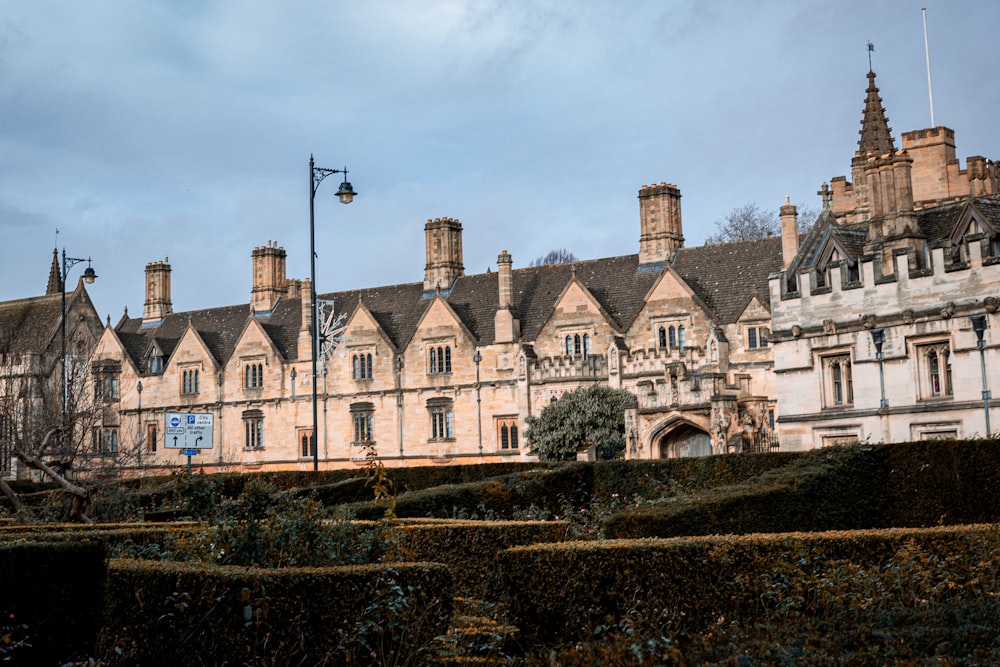 a large building with a lot of hedges in front of it