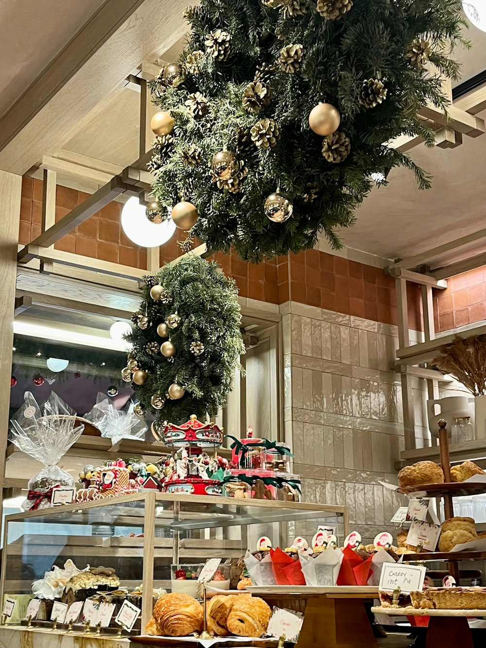 a christmas wreath hanging from the ceiling of a bakery