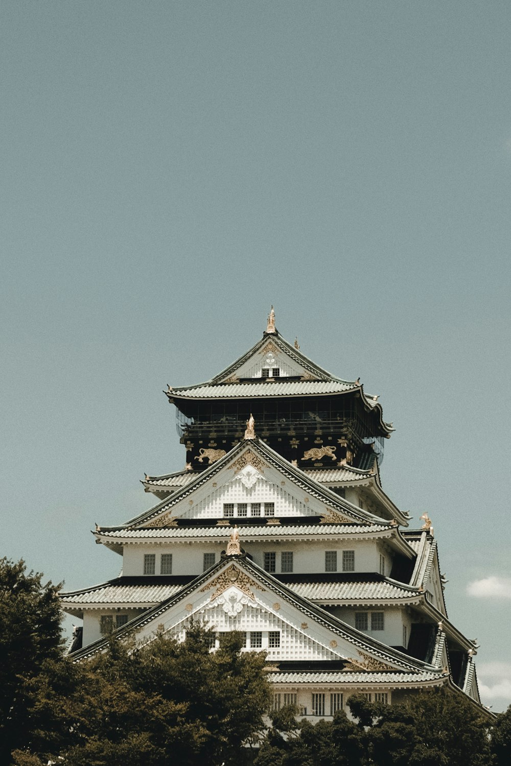 a tall white building with a clock on it's side