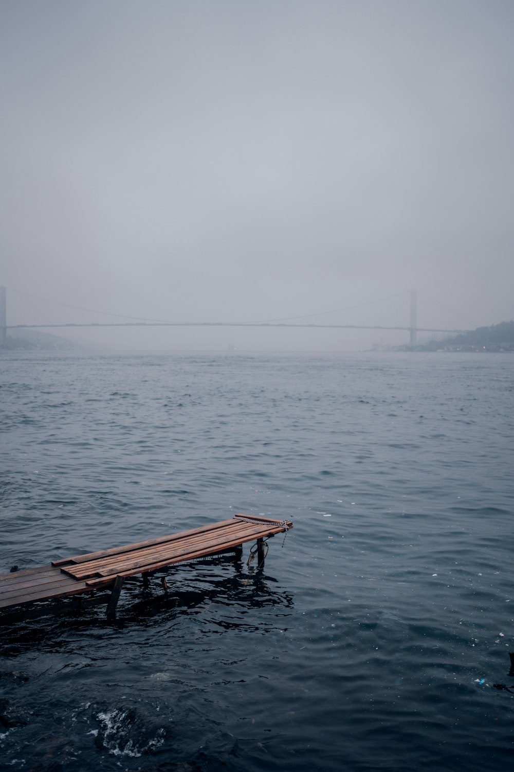 a wooden dock in the middle of a body of water