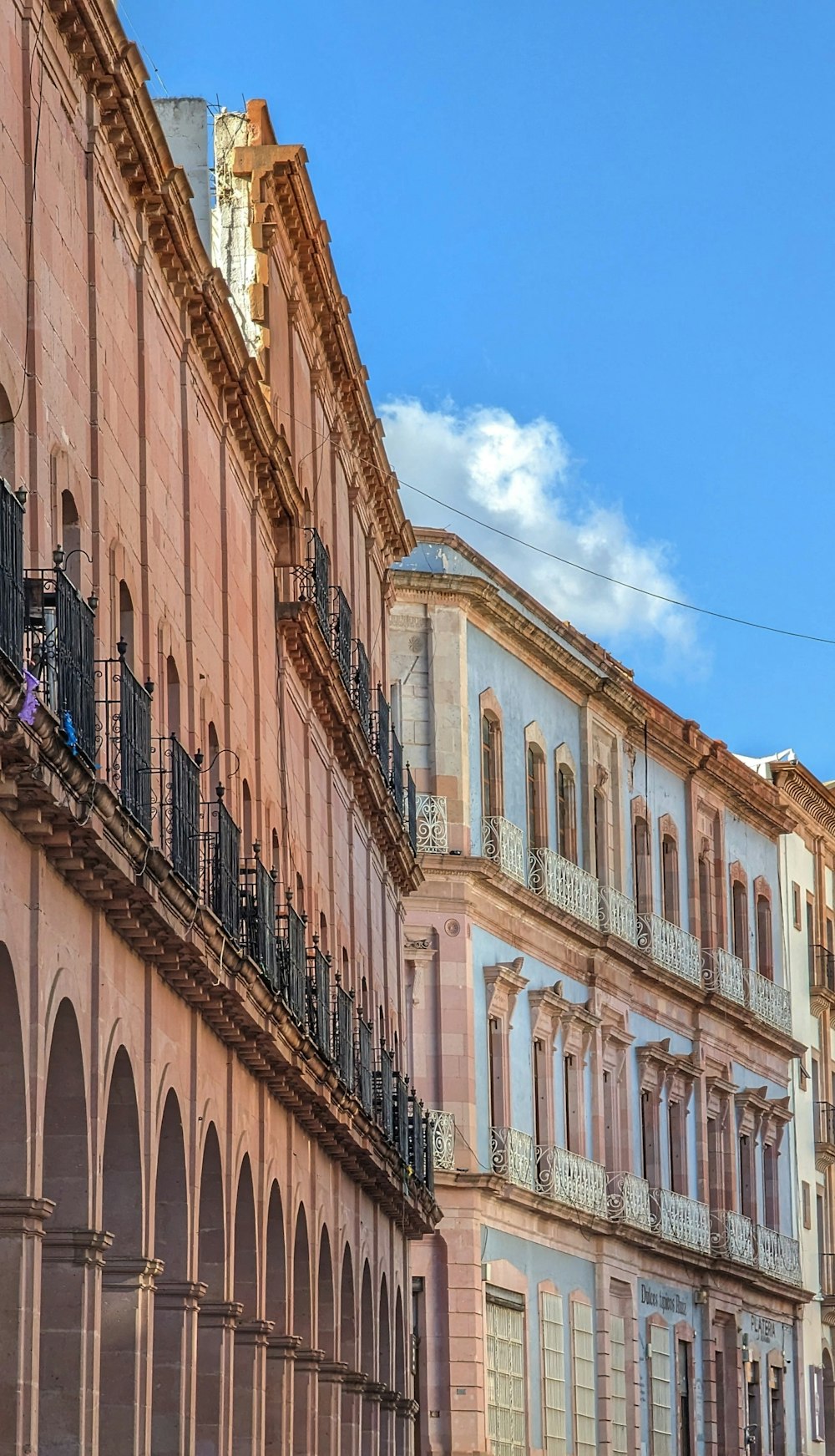 a row of old buildings with balconies and wrought iron balconies