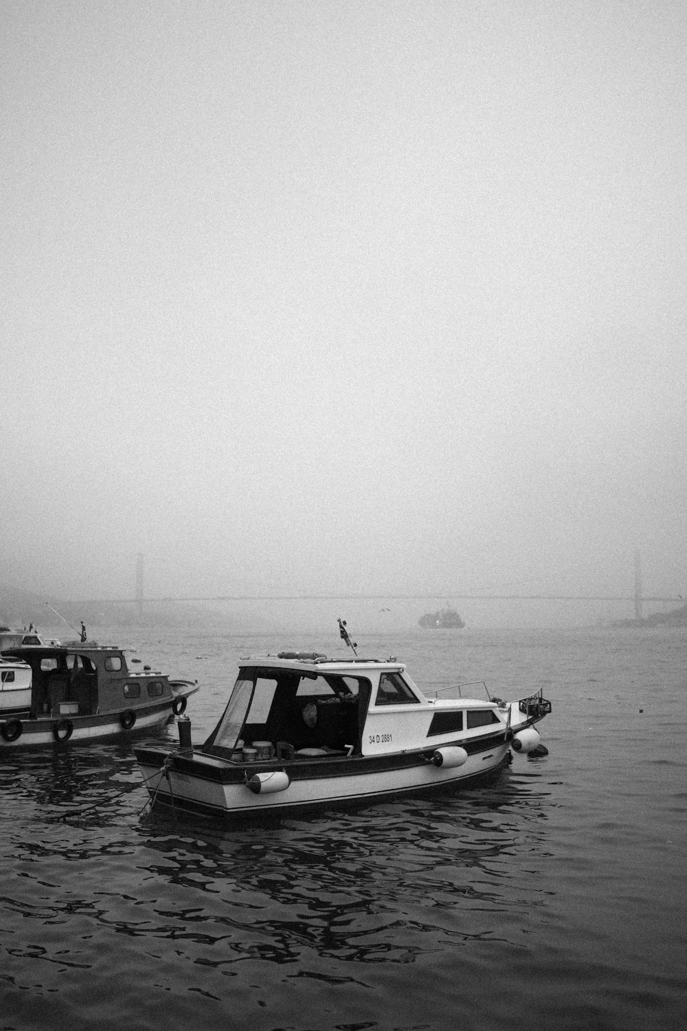 a couple of boats floating on top of a body of water