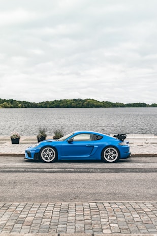 A vibrant blue car parked in a scenic location in Albacete.