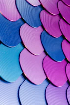 Close-up of a golden dragon scale pattern with neon purple highlights.