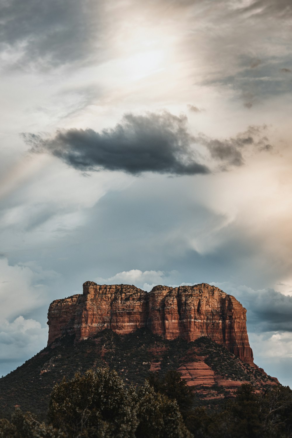 a very tall mountain with a cloudy sky in the background