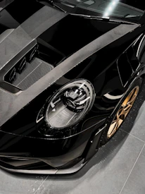 Side view of a luxury sports car equipped with Velaris carbon fiber rims, set against a dark, cinematic background.