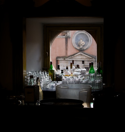 Behind-the-scenes shot of the founder arranging glassware and spirits before an event in Milwaukee.