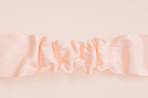 Soft Apricot alphine fabric draped elegantly, showing its smooth blend of rayon and polyester.