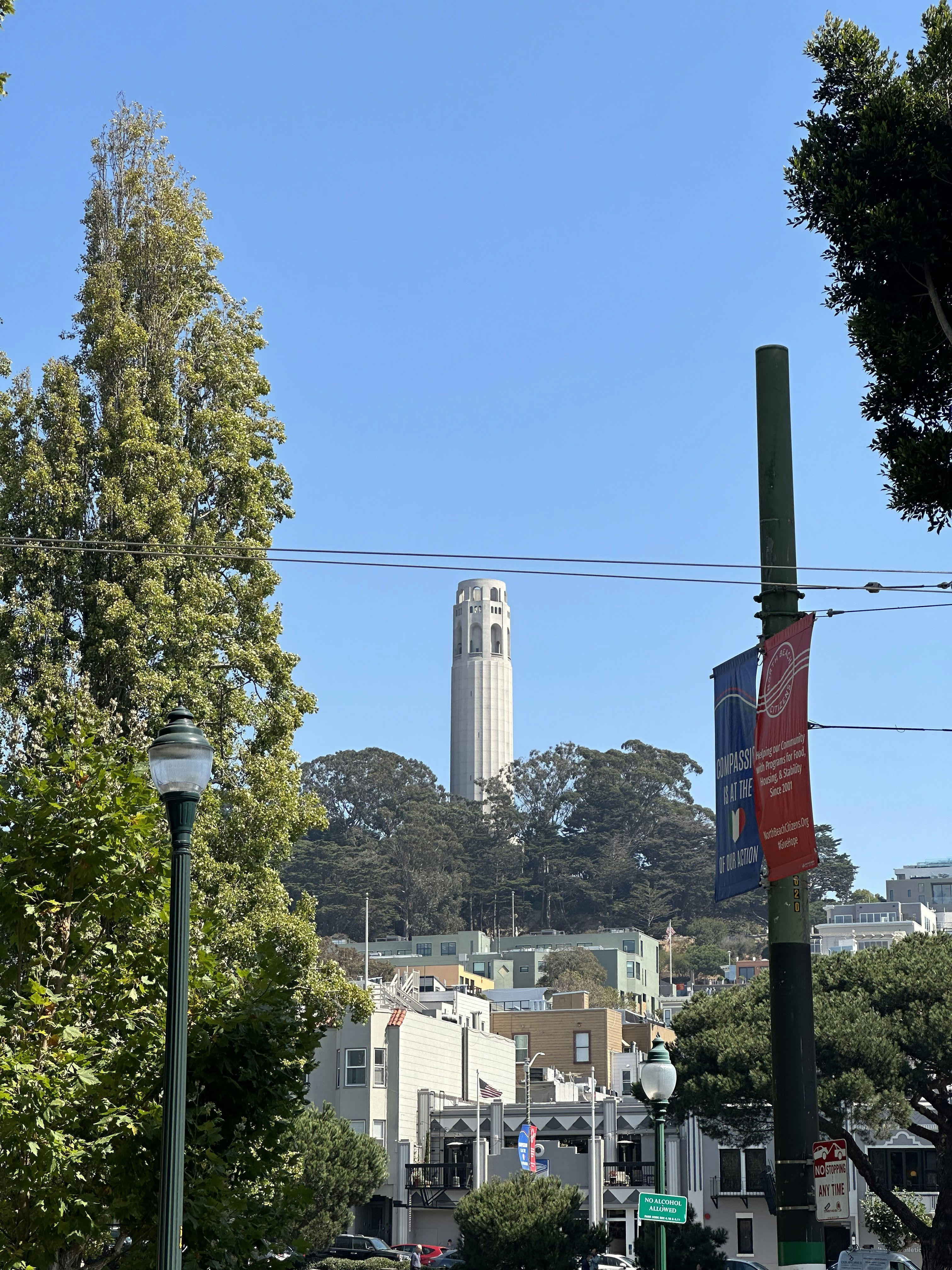 a city street with a tall building in the background