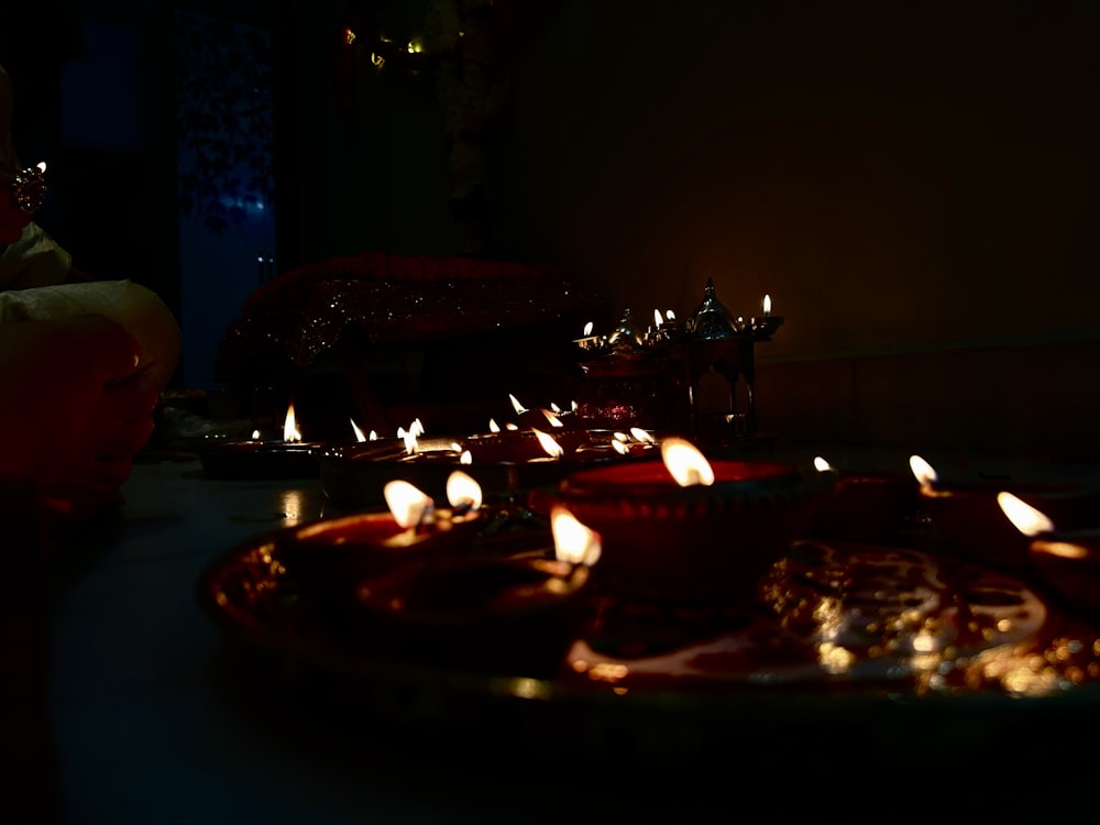 a group of lit candles sitting on top of a table