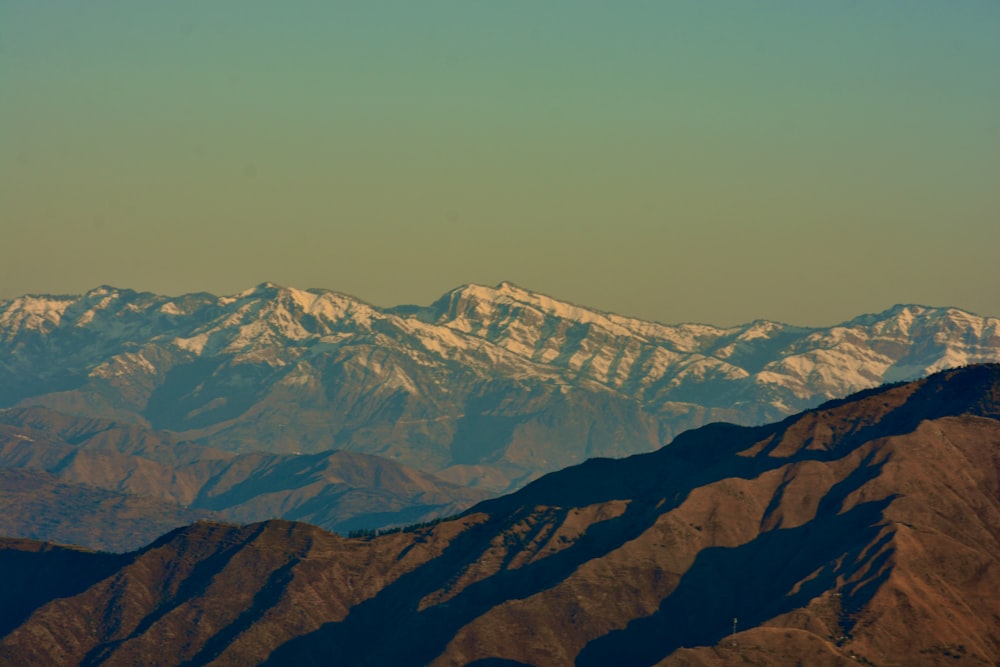 a mountain range with snow covered mountains in the background