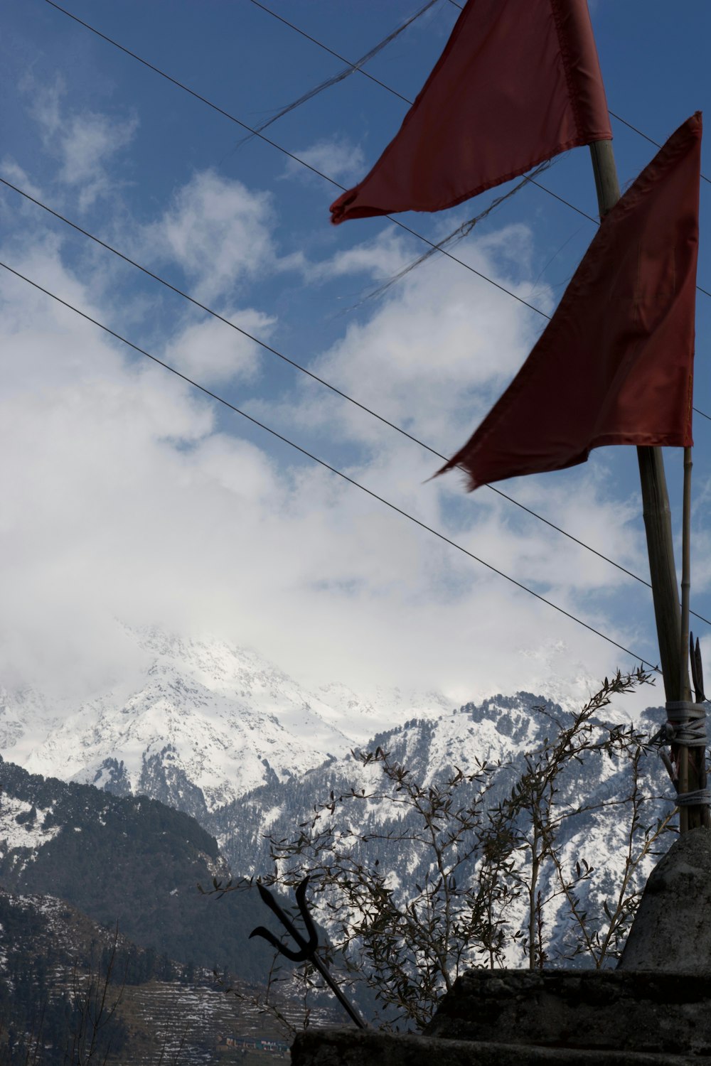 two red flags in front of a snowy mountain