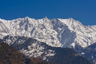 a snow covered mountain range in the distance