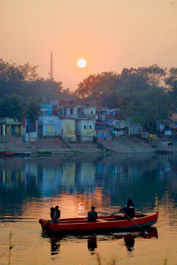 A small group of travelers enjoying a serene riverside sunset in Southeast Asia.