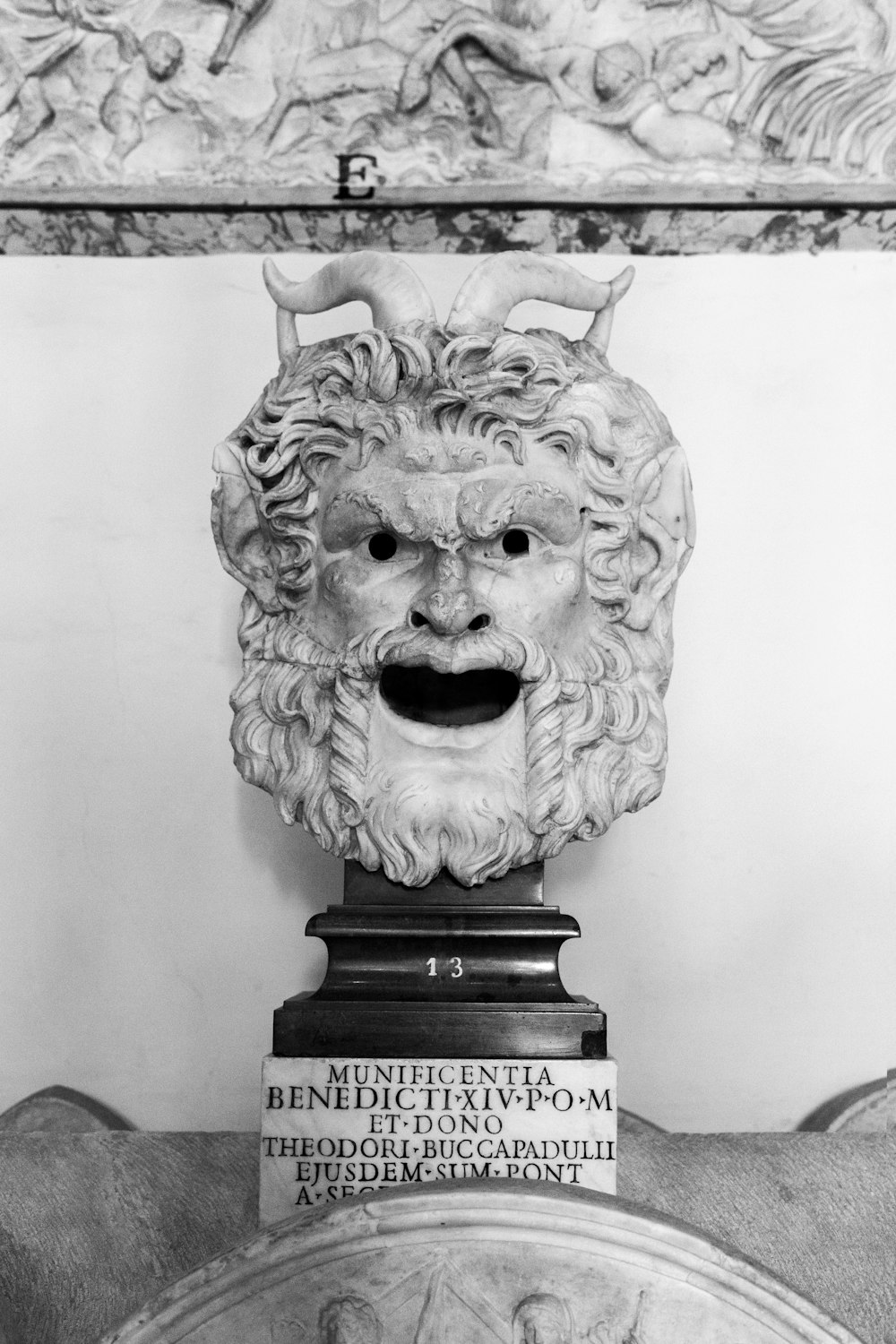 a black and white photo of a bust of a lion