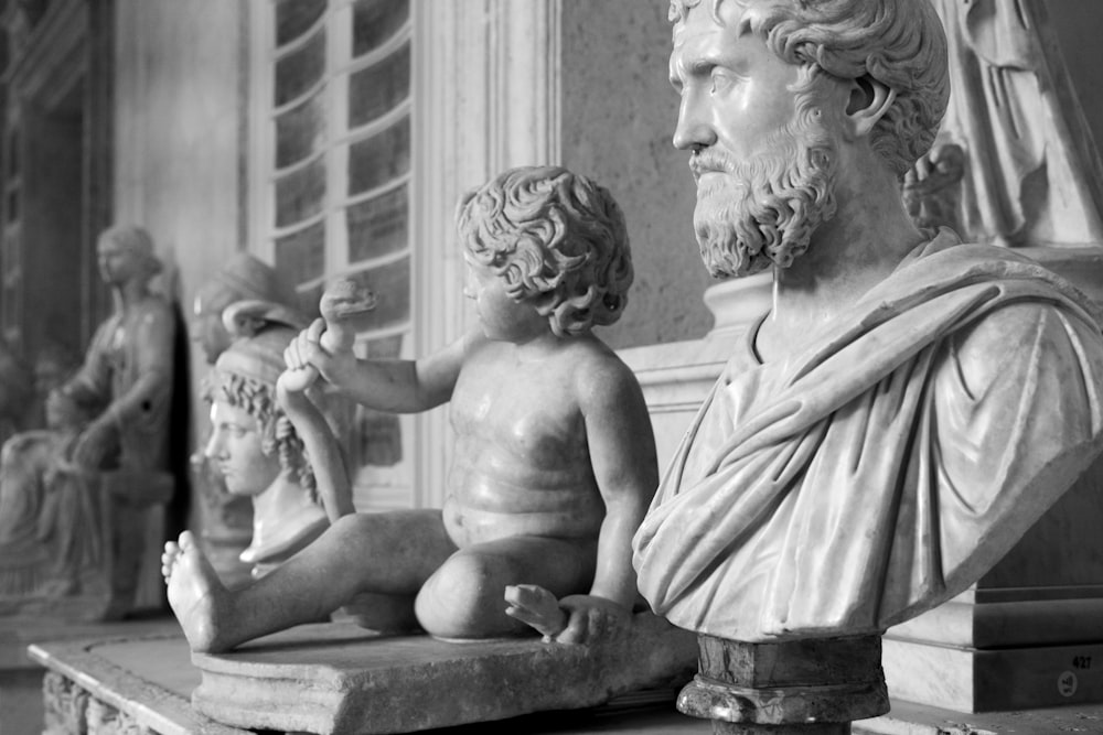 a black and white photo of a statue of a man and child