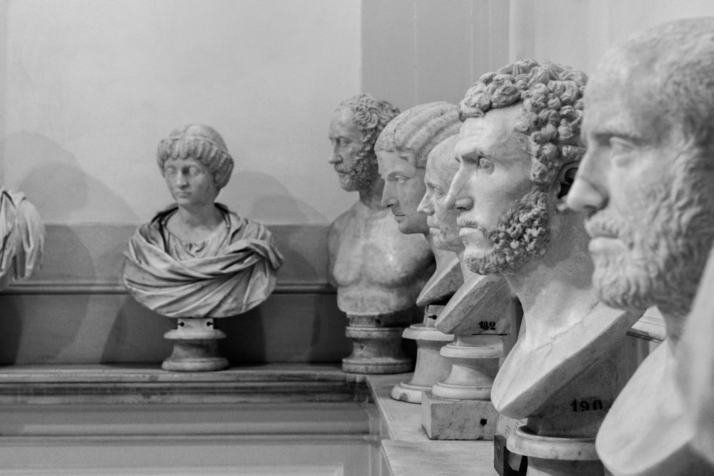 a row of marble busturines in a museum
