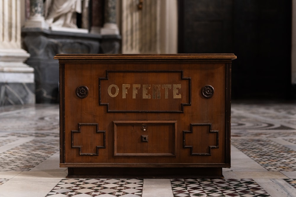 a wooden box sitting on top of a tiled floor