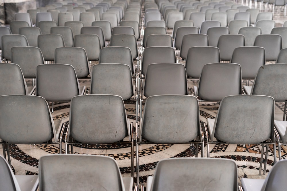 rows of empty chairs sitting in a room