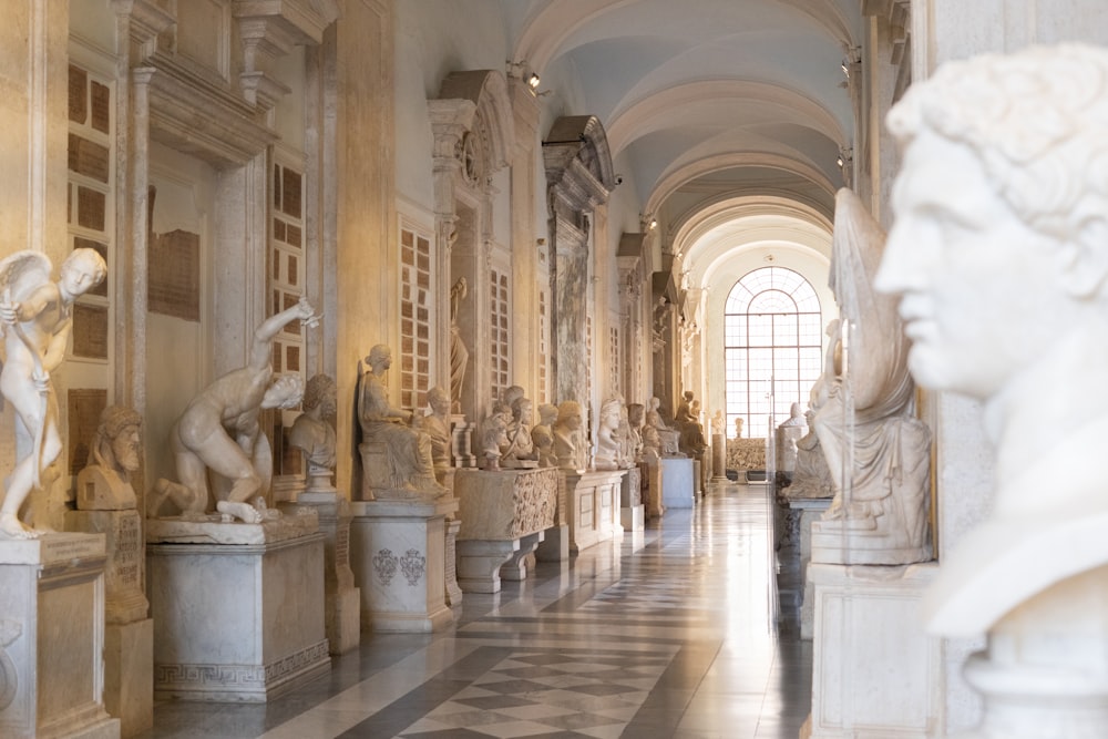 a long hallway with statues on either side of it