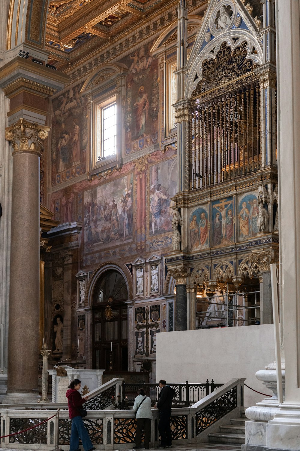 a person standing in a large room with a painting on the wall