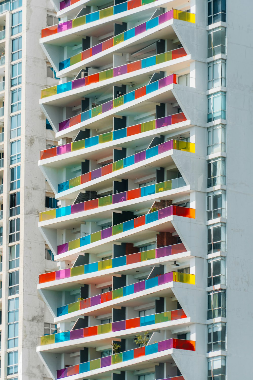 a multicolored building with a clock in front of it