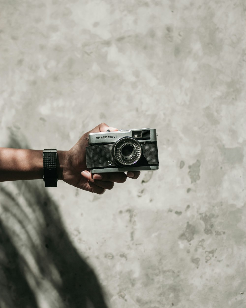 a person holding a camera in their hand