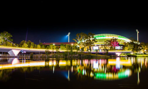 A vibrant sports event with athletes competing under bright stadium lights.