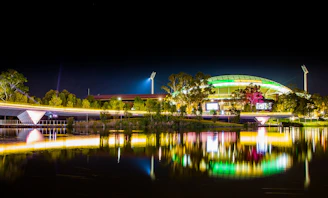 A dynamic stadium lit up at night with athletes in action, reflecting energy and professionalism.