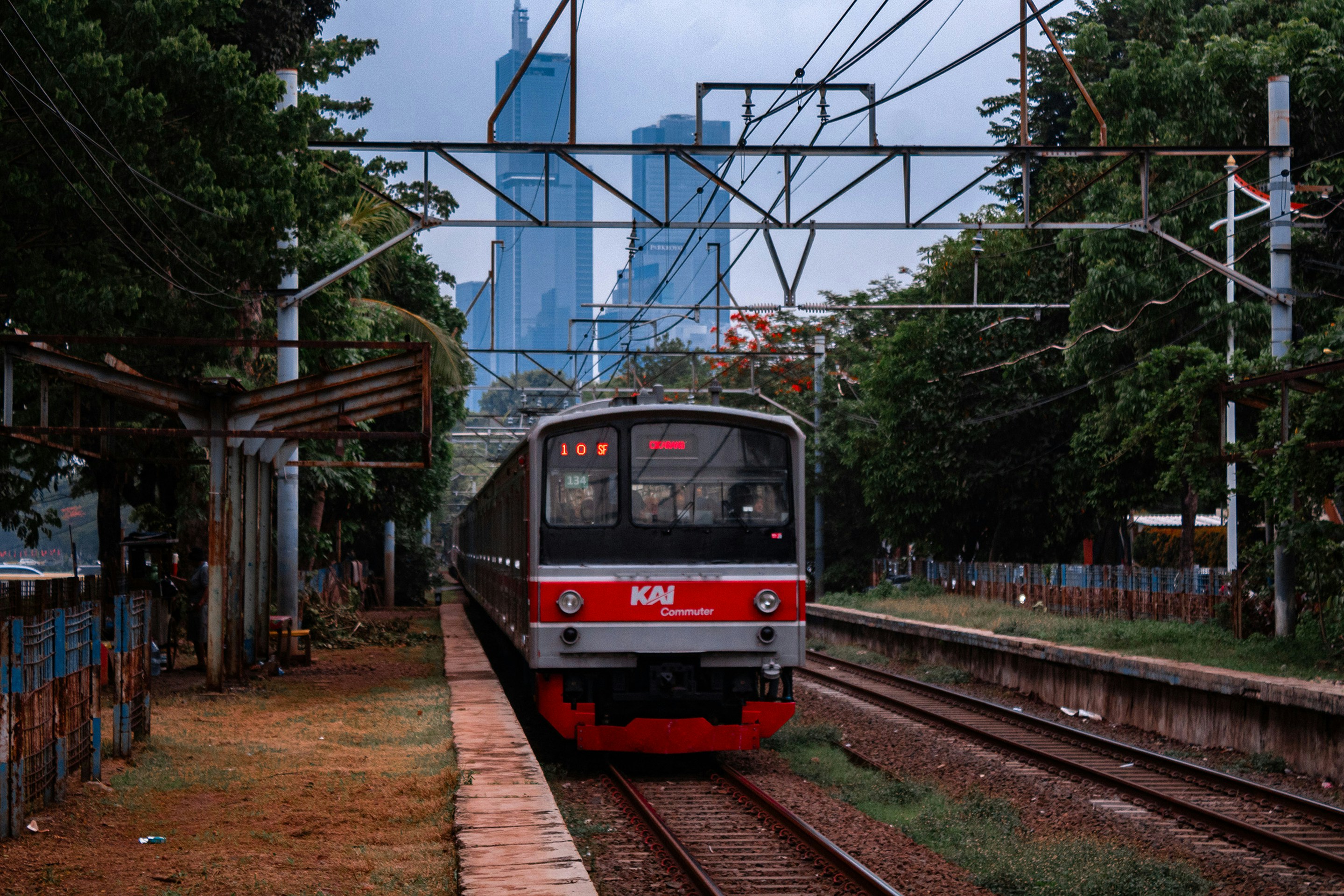 a red and white train traveling down train tracks