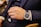 A happy customer wearing a luxury watch in a bright setting.