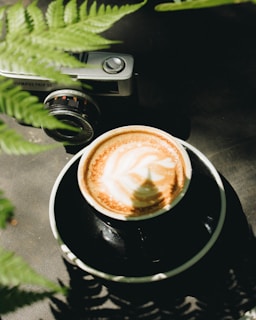 A professional photographer capturing coffee preparation in a cozy café.