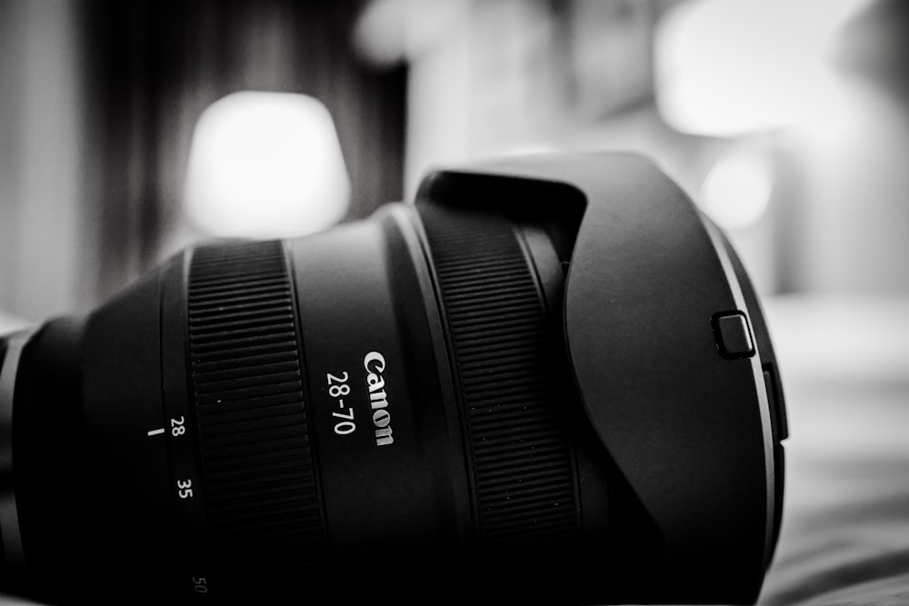 a camera lens sitting on top of a bed