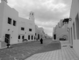 Monochrome image of a quiet street lined with charming townhouses.