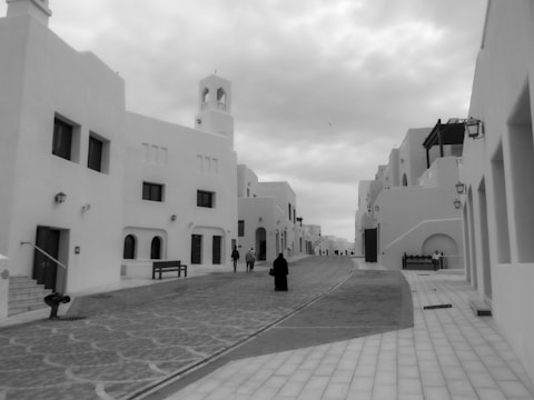 Monochrome image of a quiet street lined with charming townhouses.