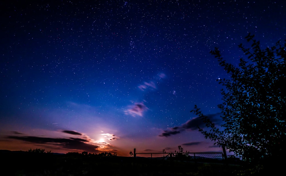 a night sky with stars and clouds