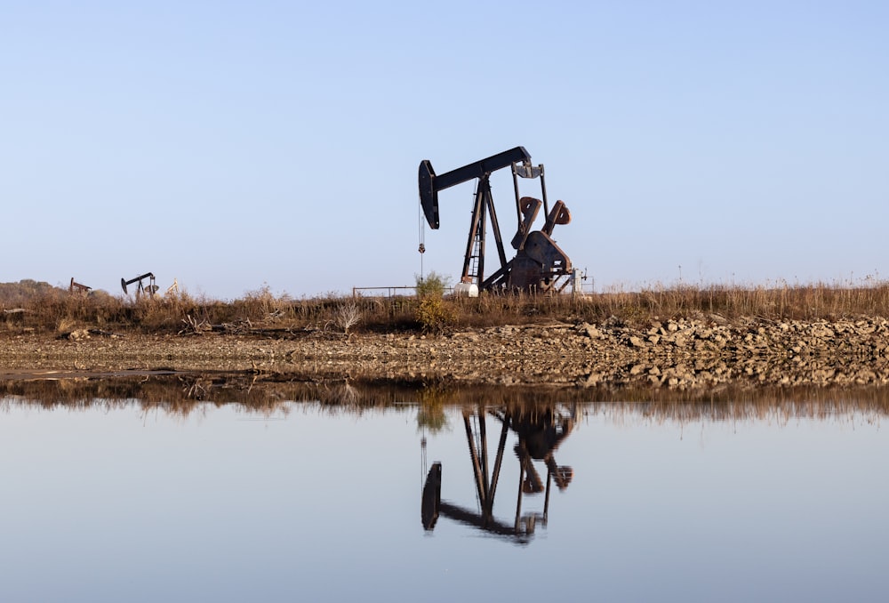 an oil pump sitting next to a body of water