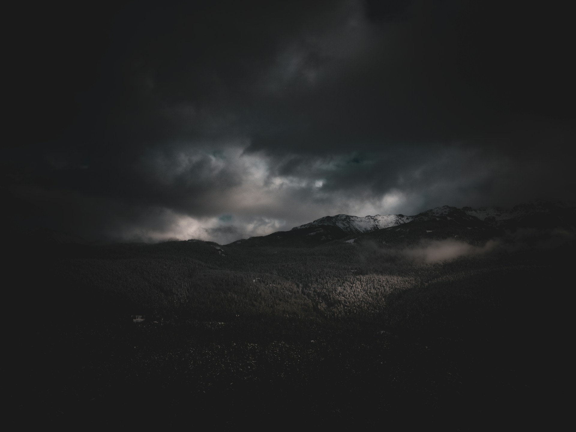 a black and white photo of a mountain range