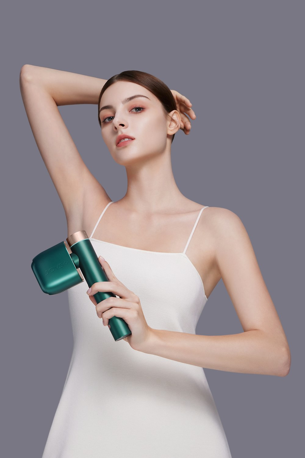 a woman in a white dress holding a green hair dryer