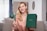 A smiling woman holding the pelvic floor strengthening device.