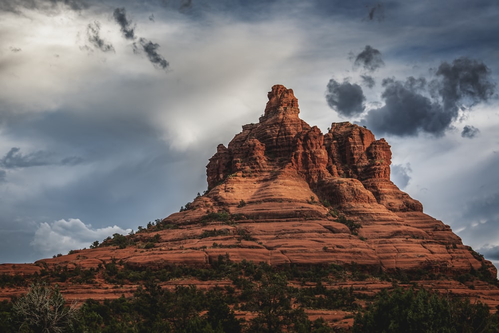 a very tall mountain with a sky in the background