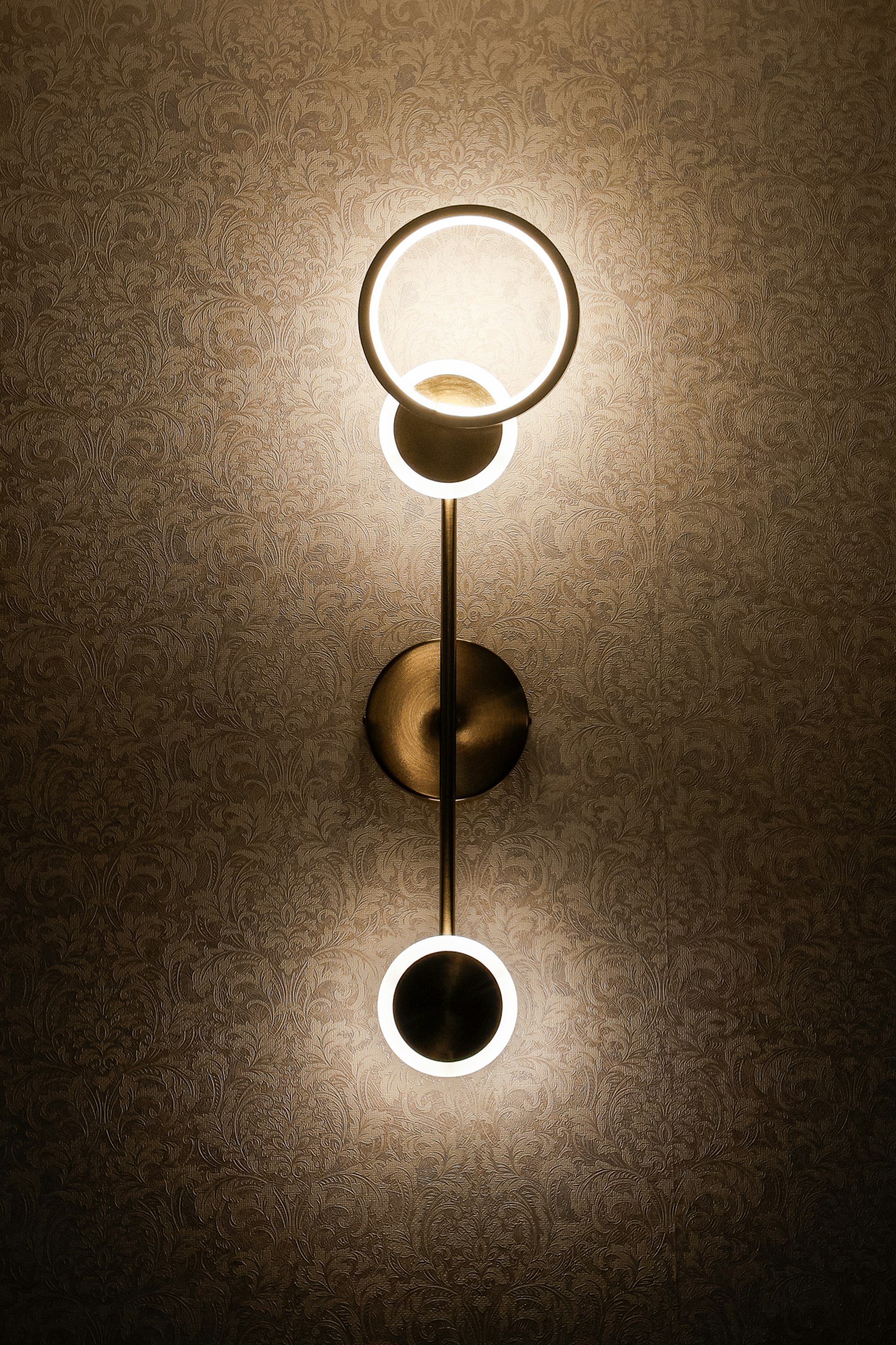 An elegant accent wall with custom wallpaper and integrated lighting, highlighting the craftsmanship of Artful Custom Interiors in a modern residential space.