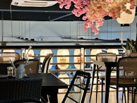 The warm interior of new chicken bun bun inc with wooden tables and soft lighting.