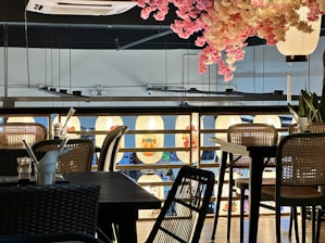 Cozy interior of Sakura Fusion restaurant with wooden tables and soft lighting.