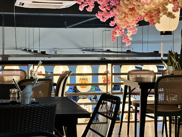Cozy interior of Sakura Fusion restaurant with wooden tables and soft lighting.
