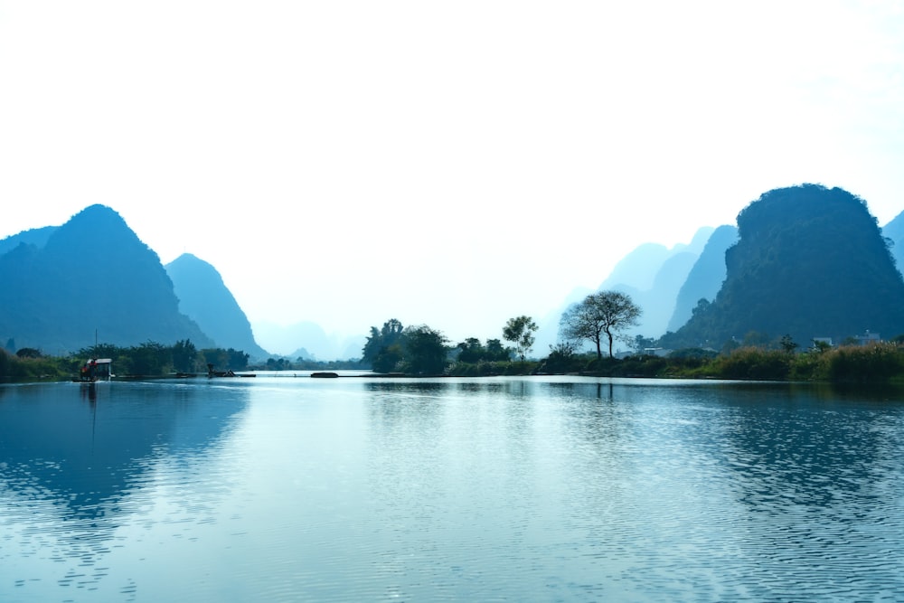 a body of water with mountains in the background