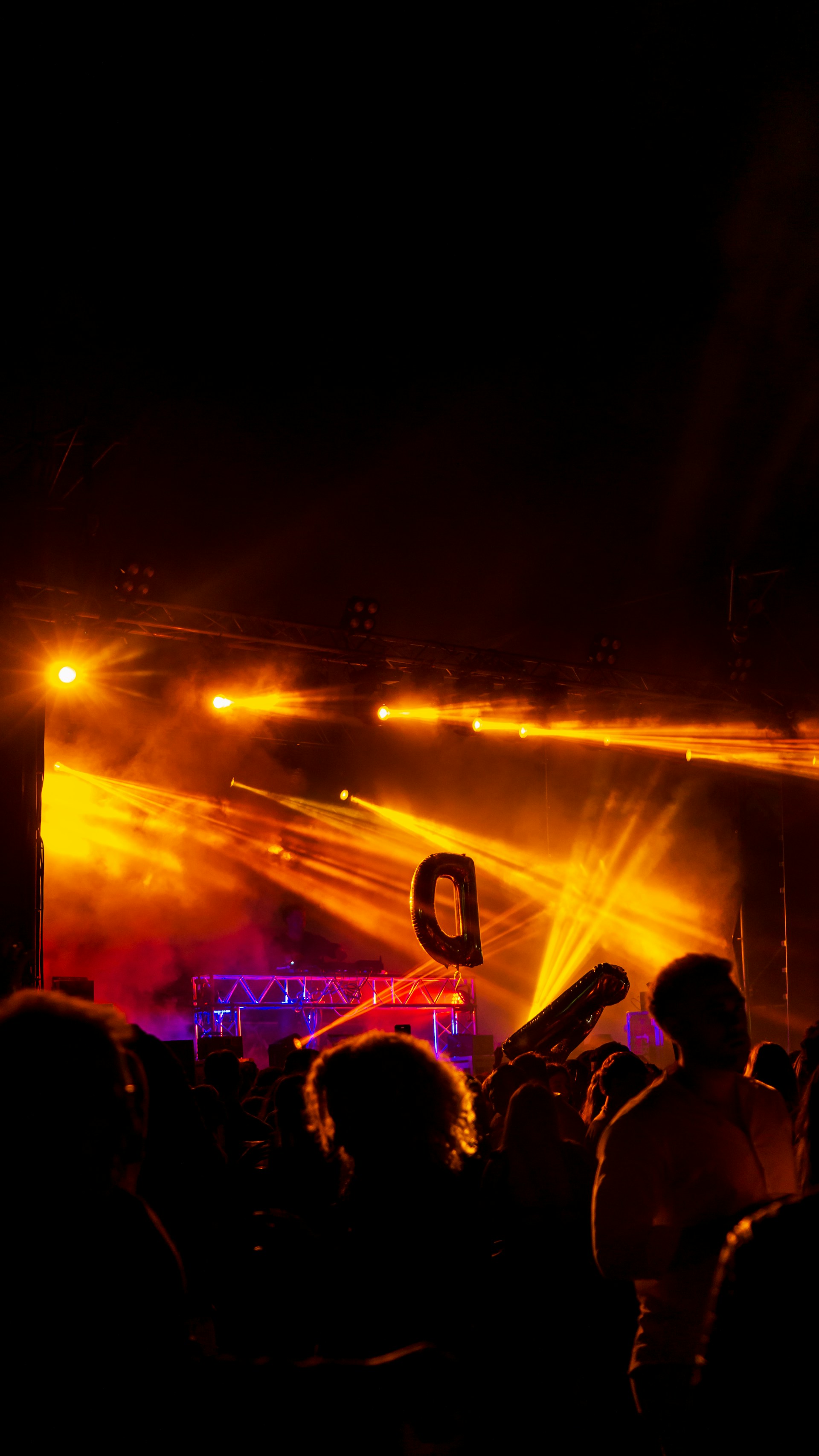 Photo of d-sastres performing energetically on stage at a lively outdoor festival.