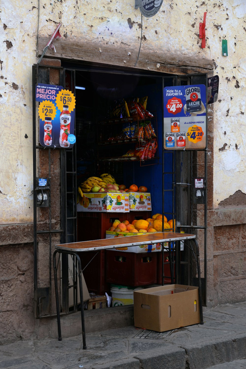 a fruit stand on the side of a building