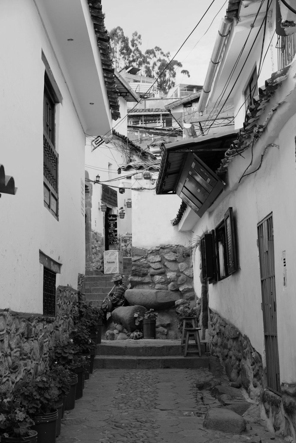 a black and white photo of a narrow street