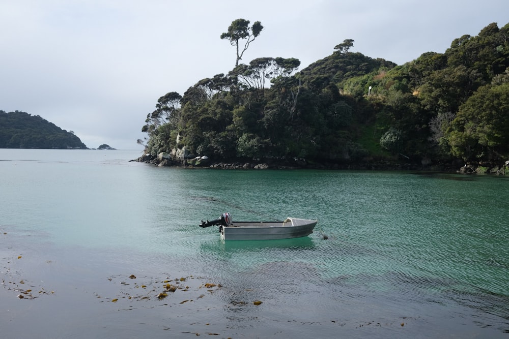 a small boat floating on top of a body of water